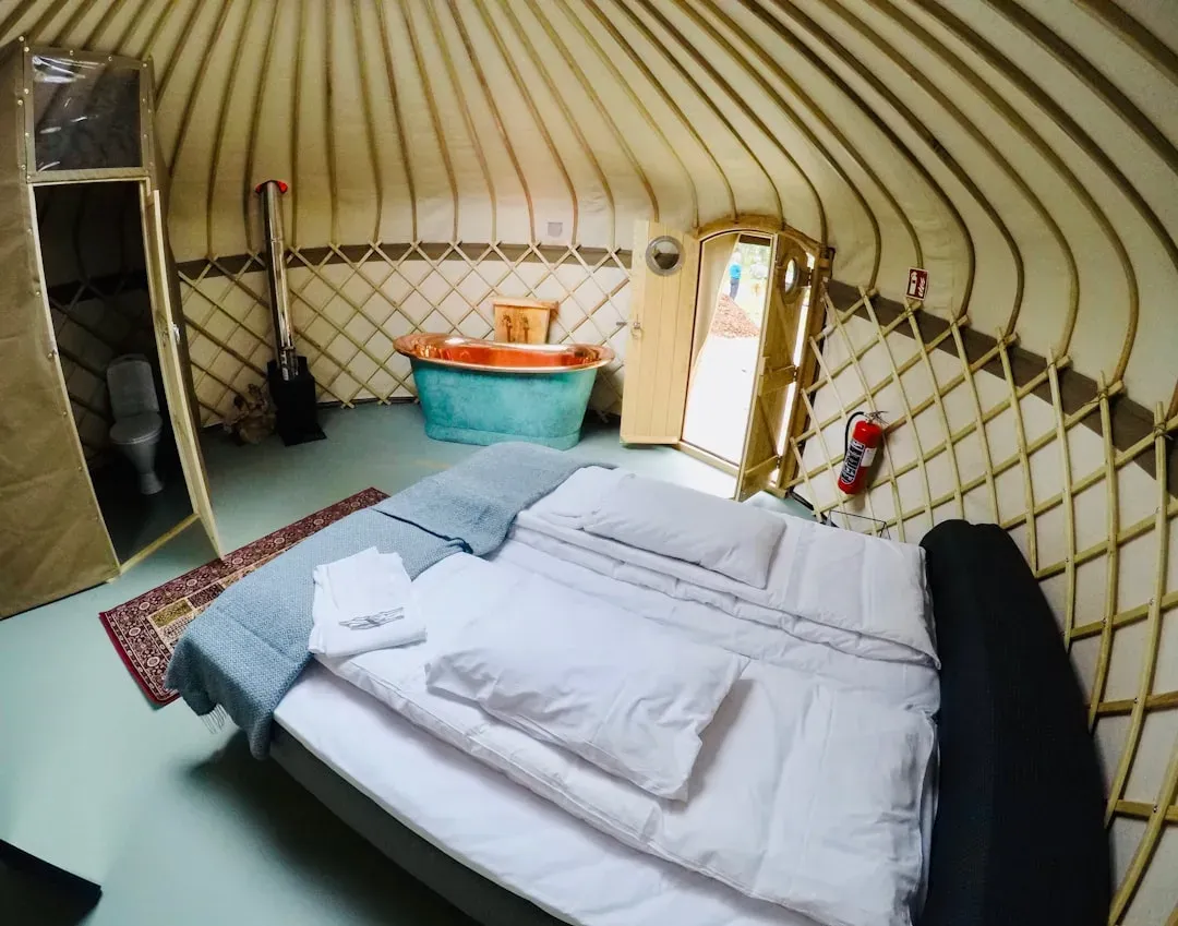 cozy yurt interior with sleeping bags and trekking gear